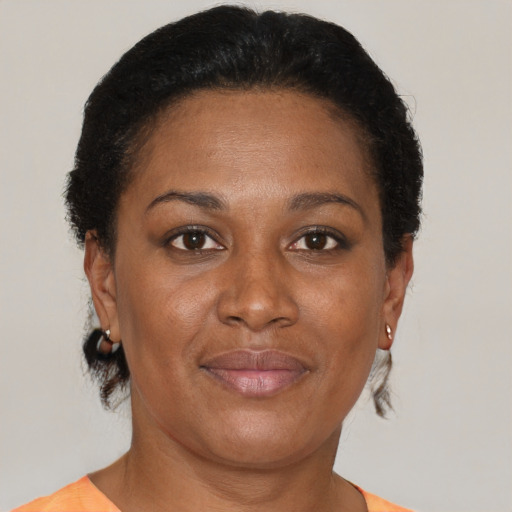 Joyful black adult female with short  brown hair and brown eyes