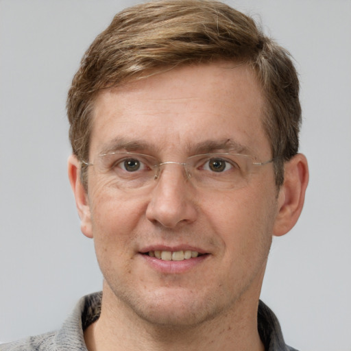 Joyful white adult male with short  brown hair and grey eyes