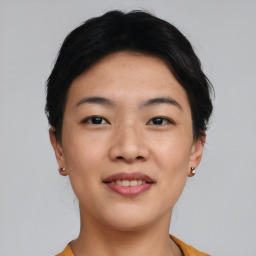 Joyful asian young-adult female with short  black hair and brown eyes