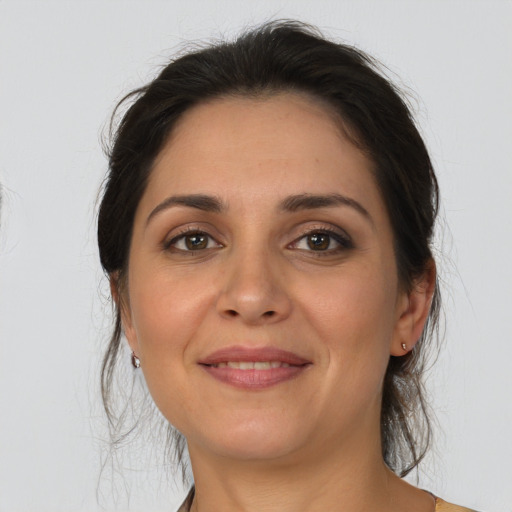 Joyful white adult female with medium  brown hair and brown eyes