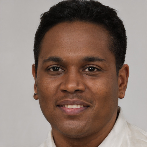 Joyful black young-adult male with short  black hair and brown eyes