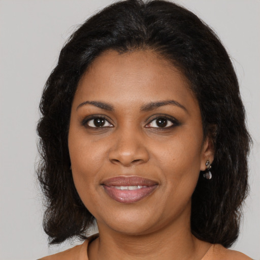 Joyful black young-adult female with medium  brown hair and brown eyes