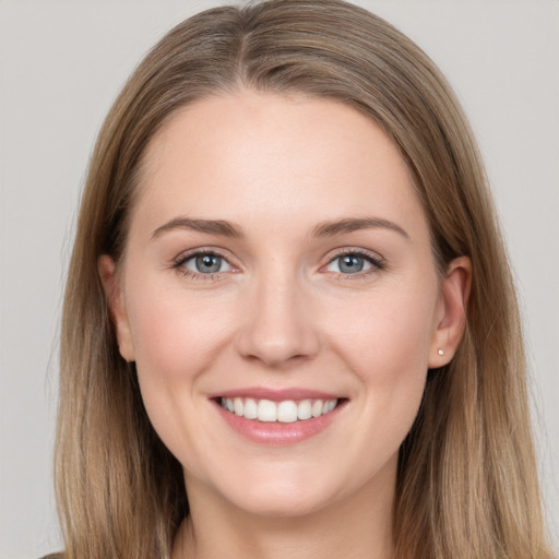 Joyful white young-adult female with long  brown hair and grey eyes