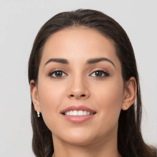 Joyful white young-adult female with long  brown hair and brown eyes