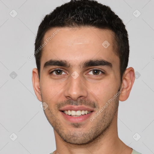 Joyful white young-adult male with short  brown hair and brown eyes