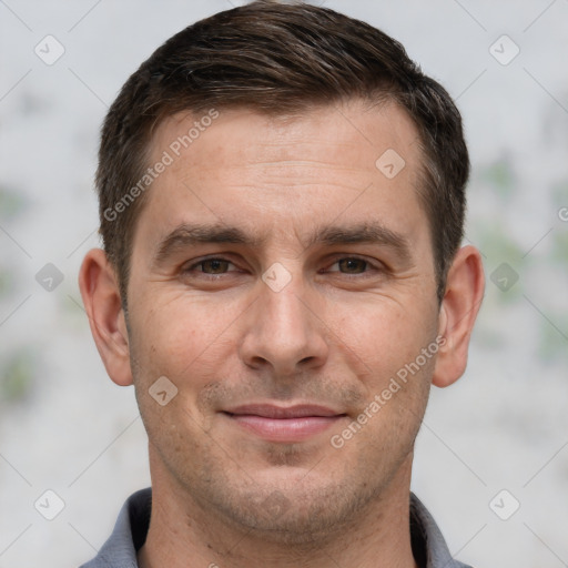 Joyful white adult male with short  brown hair and brown eyes