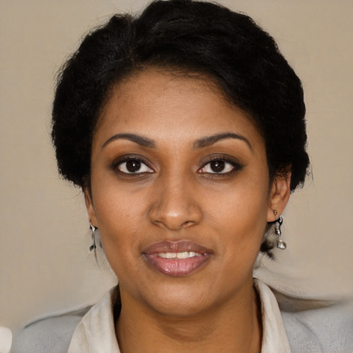 Joyful black young-adult female with short  brown hair and brown eyes