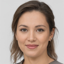 Joyful white young-adult female with medium  brown hair and brown eyes