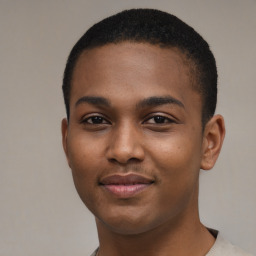 Joyful black young-adult male with short  brown hair and brown eyes