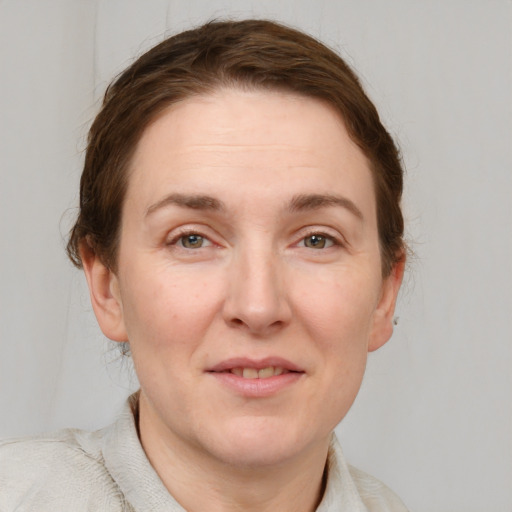 Joyful white adult female with short  brown hair and grey eyes