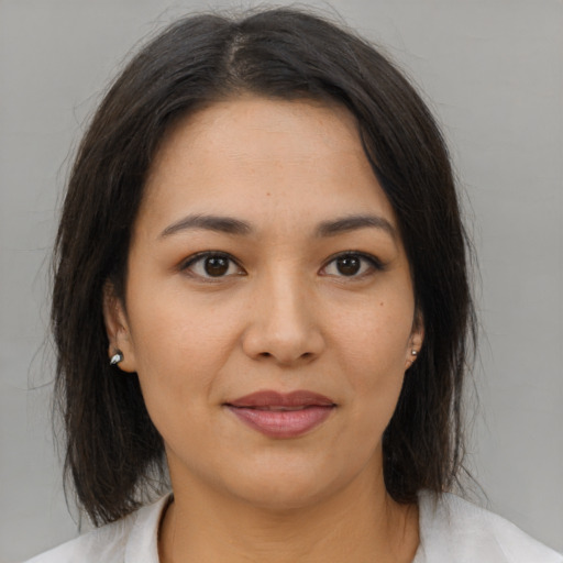 Joyful asian young-adult female with medium  brown hair and brown eyes