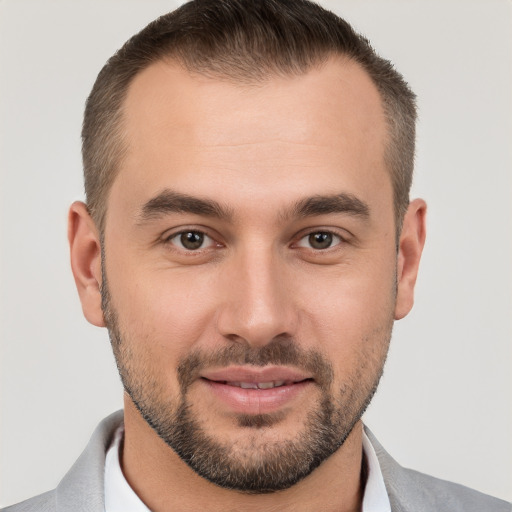 Joyful white young-adult male with short  brown hair and brown eyes