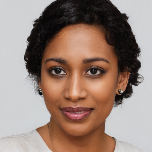 Joyful black young-adult female with medium  black hair and brown eyes