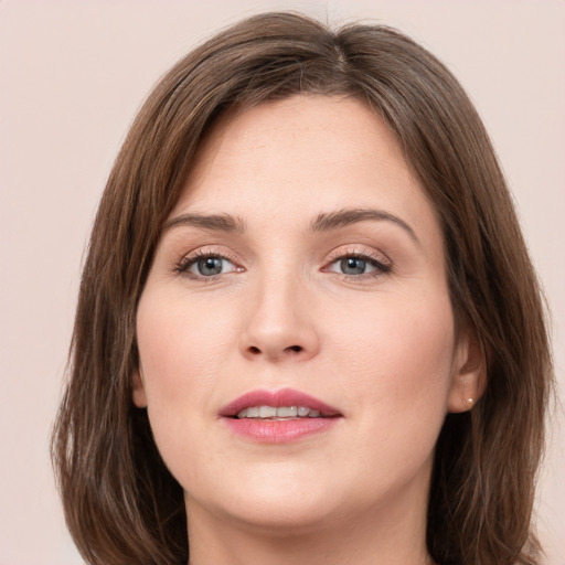 Joyful white young-adult female with medium  brown hair and green eyes