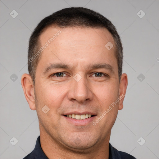 Joyful white adult male with short  brown hair and brown eyes