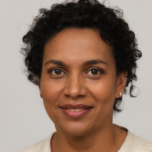Joyful black adult female with short  brown hair and brown eyes