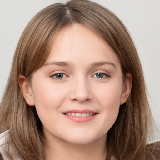 Joyful white young-adult female with long  brown hair and grey eyes