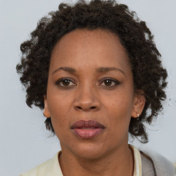 Joyful black adult female with short  brown hair and brown eyes