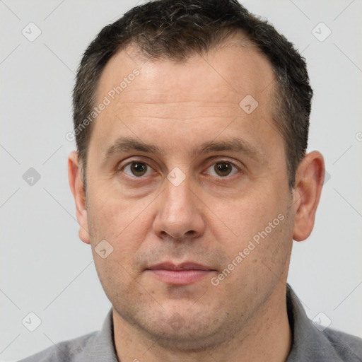 Joyful white adult male with short  brown hair and brown eyes