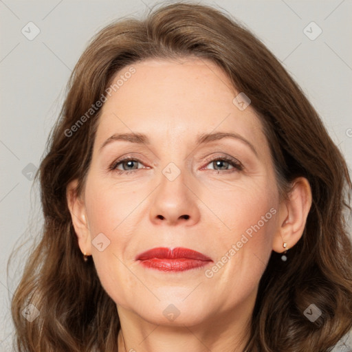 Joyful white adult female with long  brown hair and grey eyes