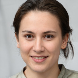 Joyful white young-adult female with medium  brown hair and brown eyes