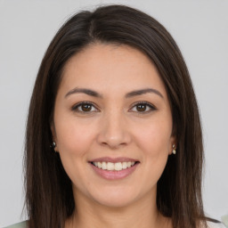 Joyful white young-adult female with long  brown hair and brown eyes