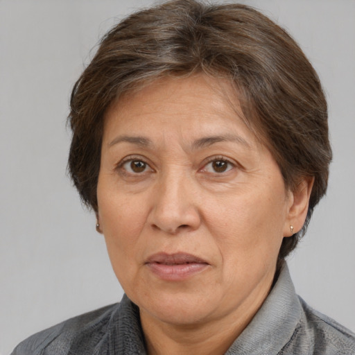 Joyful white middle-aged female with medium  brown hair and brown eyes