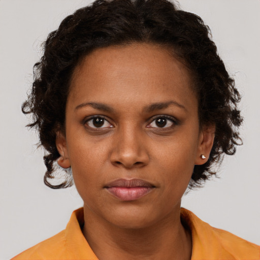 Neutral black young-adult female with medium  brown hair and brown eyes