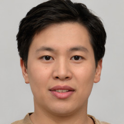 Joyful asian young-adult male with short  brown hair and brown eyes