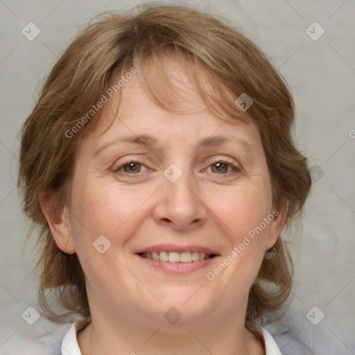 Joyful white adult female with medium  brown hair and blue eyes