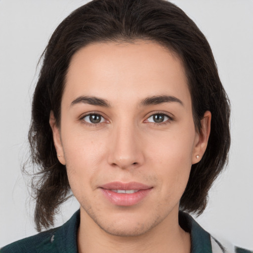 Joyful white young-adult female with medium  brown hair and brown eyes