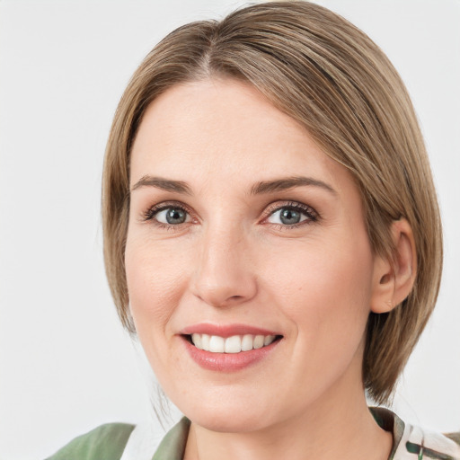 Joyful white young-adult female with medium  brown hair and green eyes