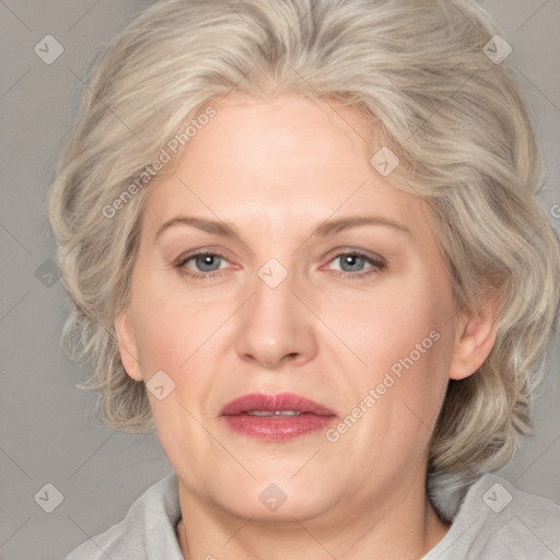 Joyful white adult female with medium  blond hair and blue eyes