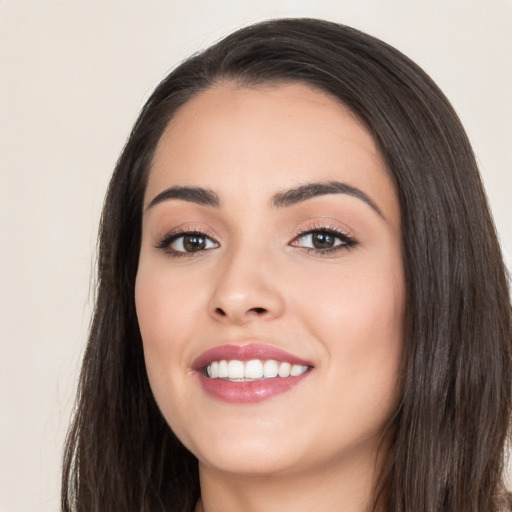 Joyful white young-adult female with long  black hair and brown eyes