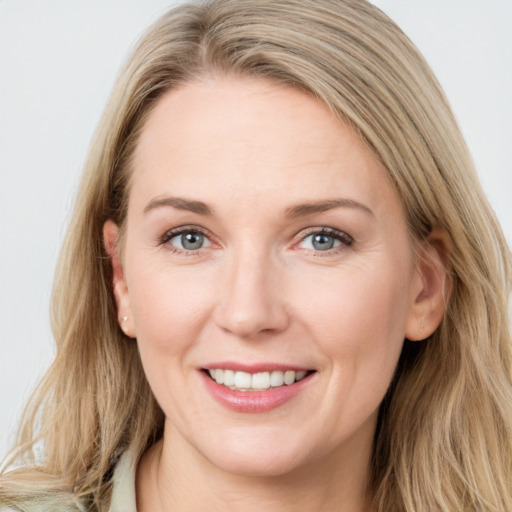 Joyful white young-adult female with long  brown hair and blue eyes