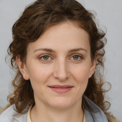 Joyful white young-adult female with medium  brown hair and green eyes