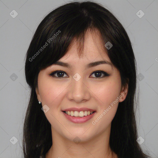 Joyful asian young-adult female with long  brown hair and brown eyes