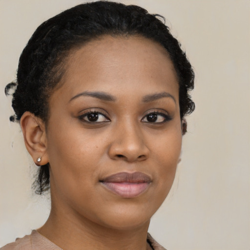 Joyful black young-adult female with short  brown hair and brown eyes