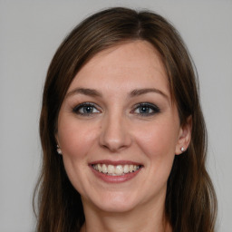 Joyful white young-adult female with medium  brown hair and grey eyes