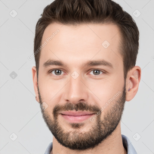 Joyful white young-adult male with short  brown hair and brown eyes