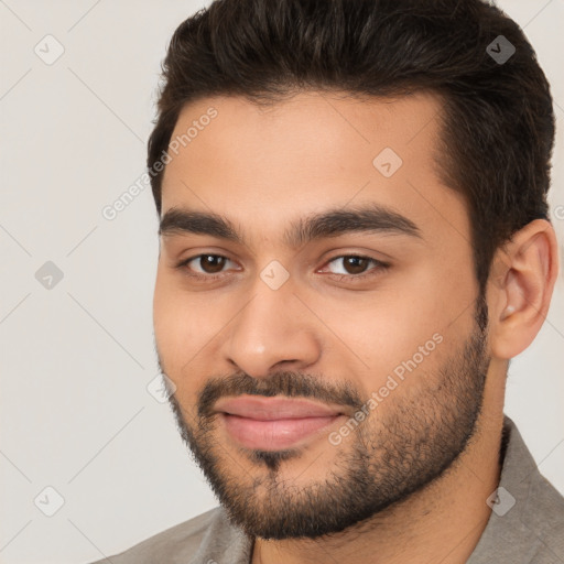 Joyful white young-adult male with short  black hair and brown eyes