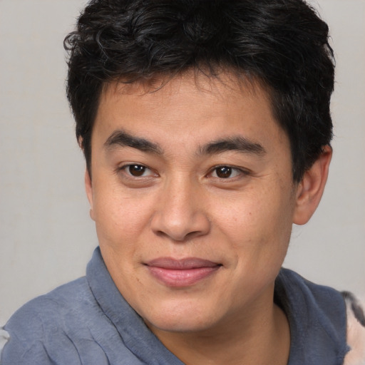 Joyful latino young-adult male with short  brown hair and brown eyes