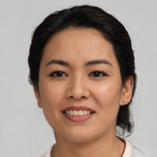Joyful latino young-adult female with medium  black hair and brown eyes