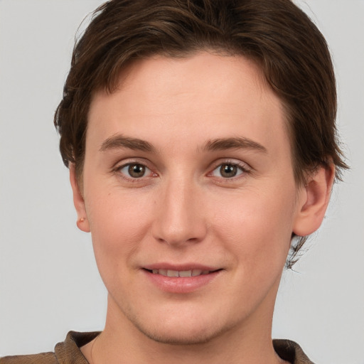 Joyful white young-adult female with short  brown hair and grey eyes