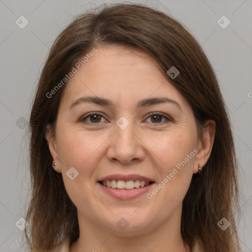 Joyful white adult female with long  brown hair and brown eyes