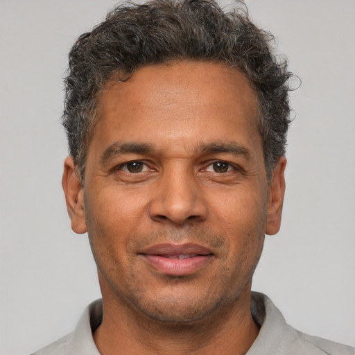 Neutral latino adult male with short  brown hair and brown eyes
