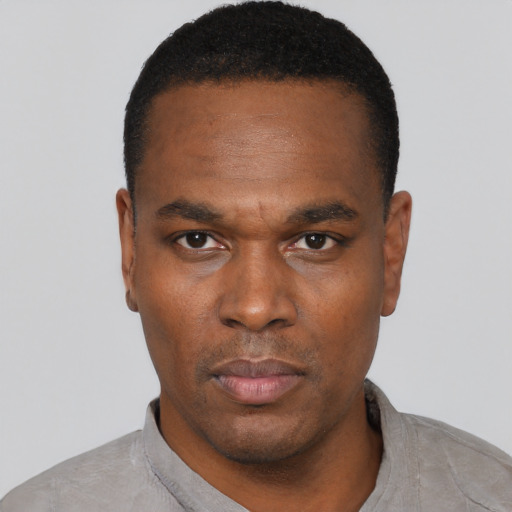 Neutral black young-adult male with short  black hair and brown eyes