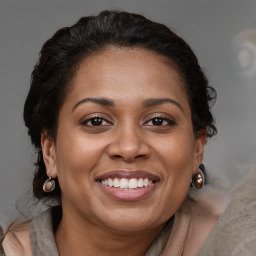 Joyful black adult female with medium  brown hair and brown eyes