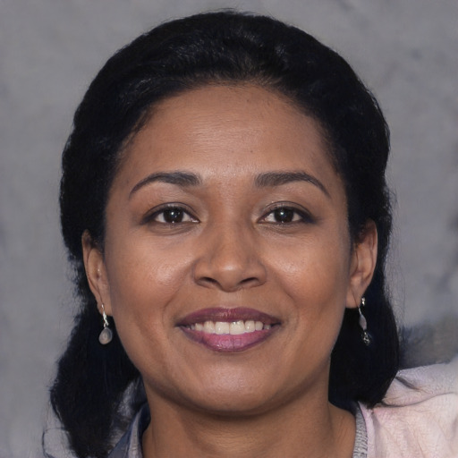 Joyful black young-adult female with medium  black hair and brown eyes