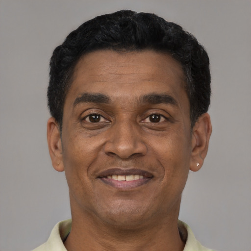 Joyful latino adult male with short  black hair and brown eyes